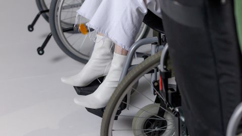 Stylish people in wheelchairs wearing trendy outfits for a modern fashion shoot.