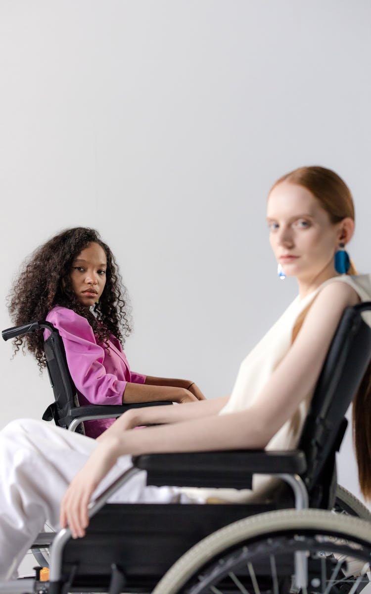 Two Women Sitting On Wheelchairs