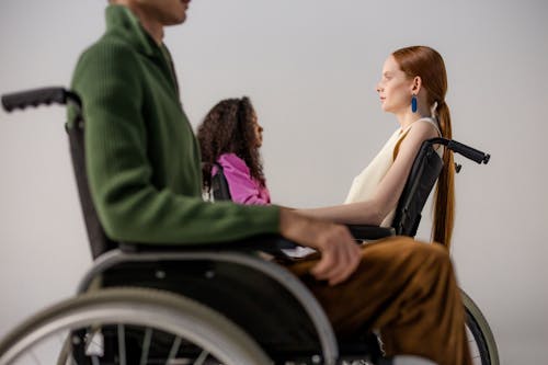 Woman in Green Blazer Sitting on Wheelchair