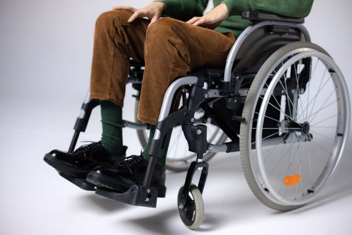 Close-up of a person seated in a wheelchair, focused on mobility