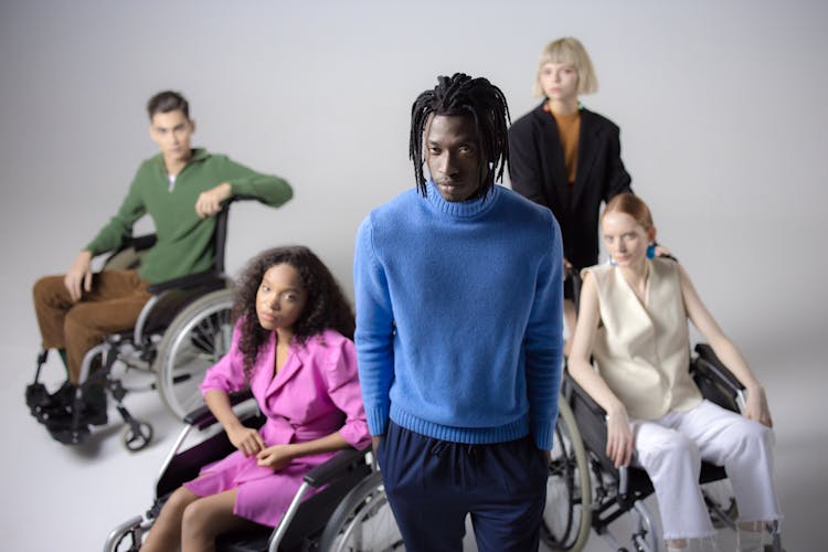 People Sitting On The Wheelchair In The White Studio