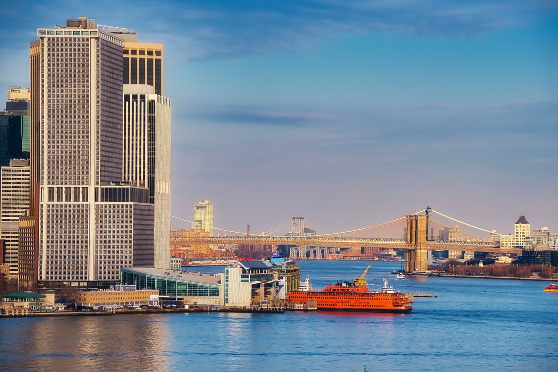 High Rise Building Near a Bridge Over a Body of Water · Free Stock Photo