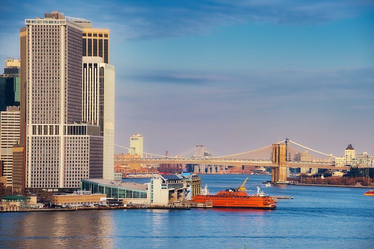 High Rise Building Near A Bridge Over A Body Of Water