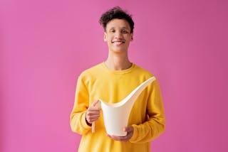 A Handsome Young Man Holding a Long Spout Plastic Watering Can