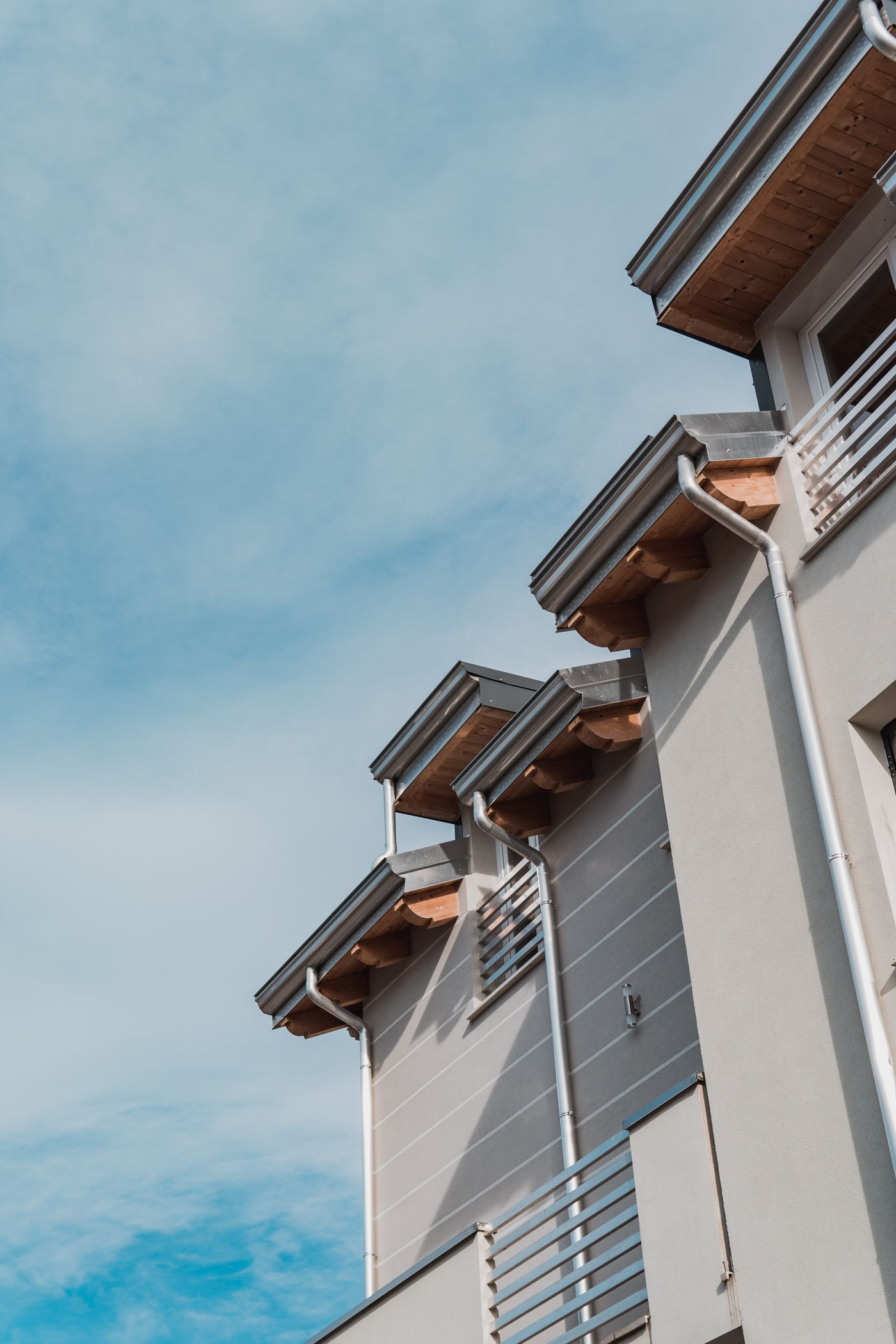 Clean fascia and eaves line on a modern house against a blue sky