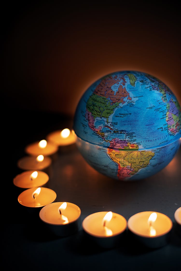 Round Globe Surrounded With Candles