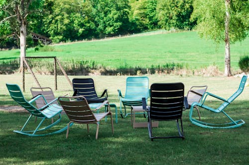 Free Green Beach Chairs on Green Grass Field Stock Photo