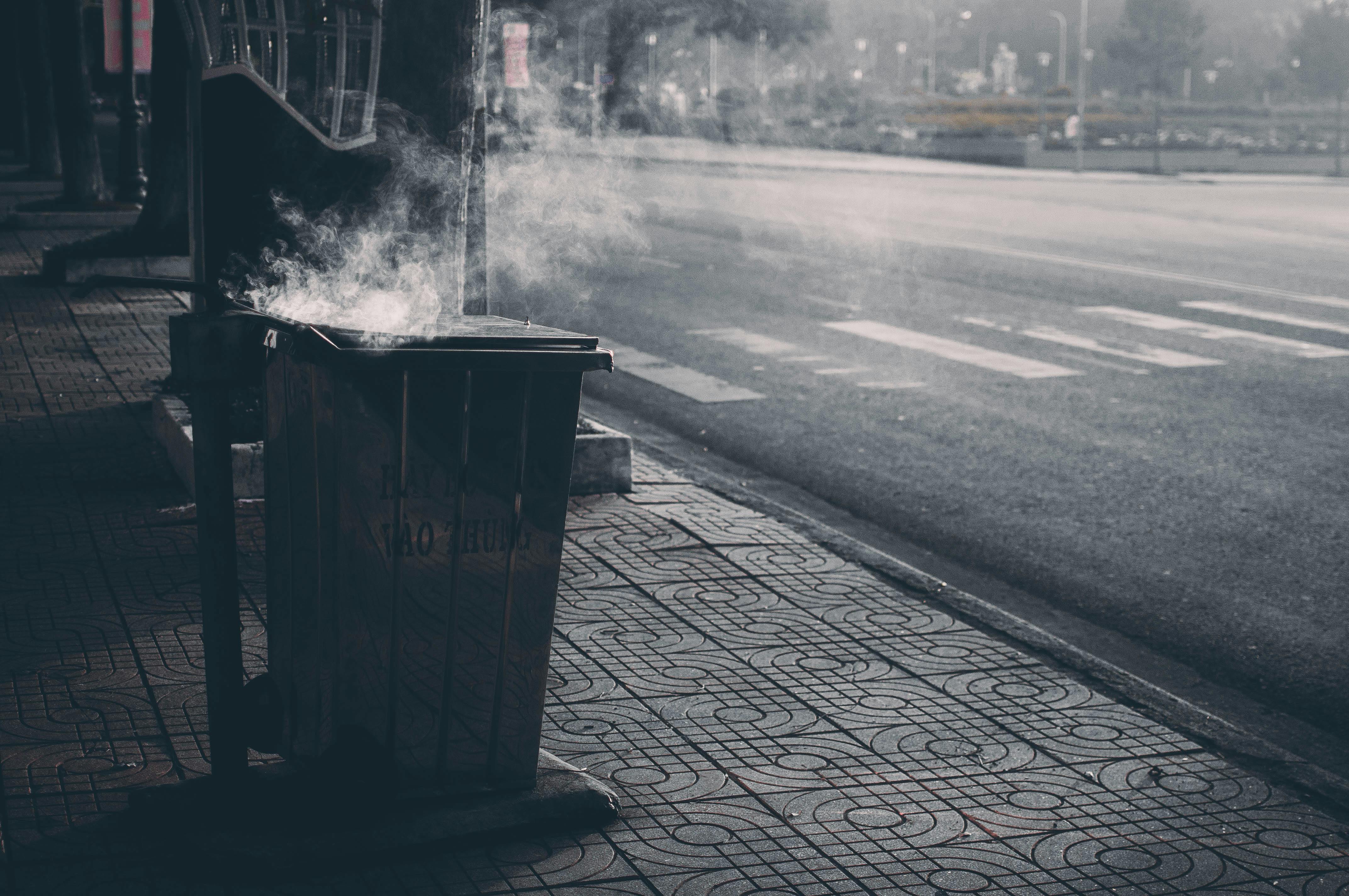 A Dirty Trash Bin on the Sidewalk · Free Stock Photo