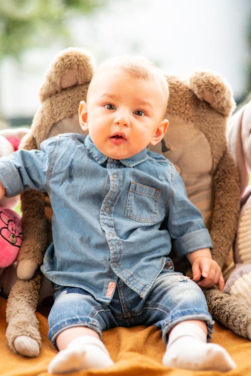 A Baby Boy in Denim Jacket Sitting 
