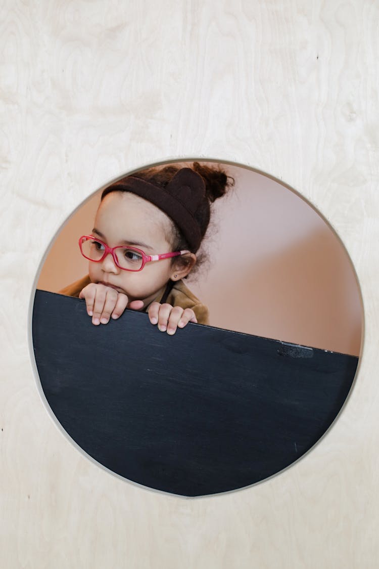 Reflection Of A Cute Little Girl Wearing Eyeglasses 