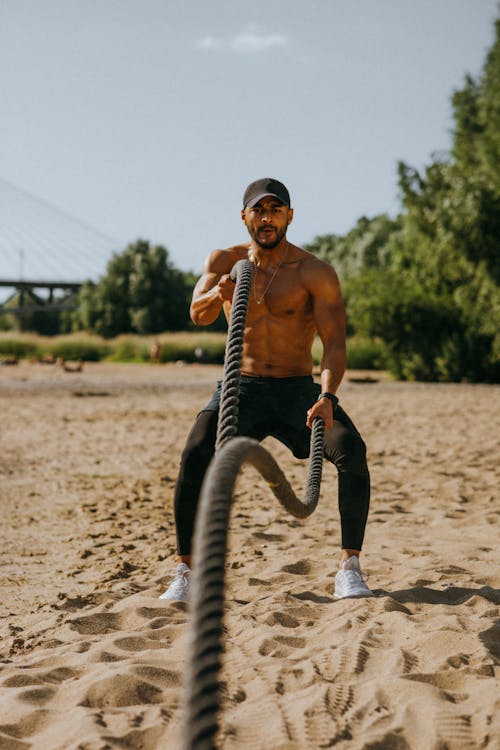 Man Training Outdoor Using Battle Ropes