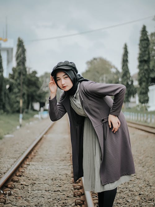 A Woman Wearing Hijab Standing on the Railway