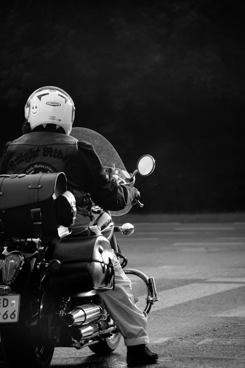 Grayscale Photo of a Person Riding a Motorcycle