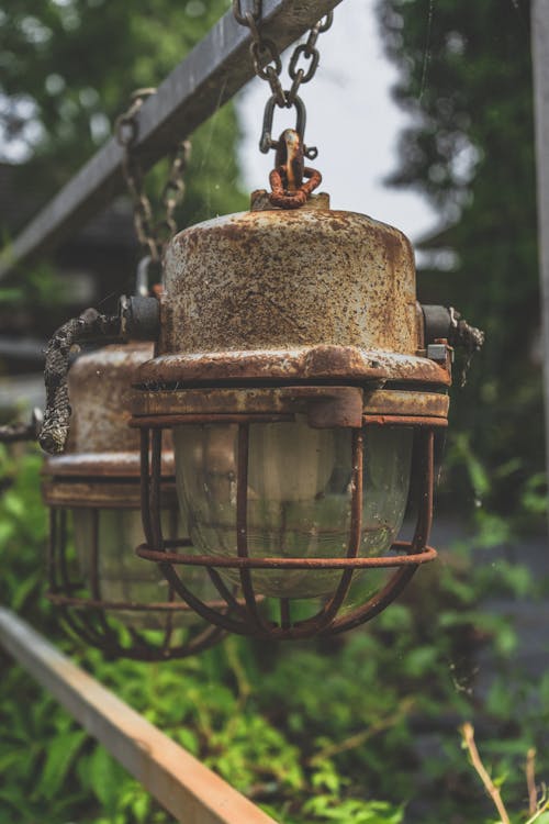 Rusty Lanterns Hanging on Metal Fence