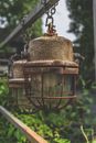 Brown Metal Lantern Hanging on Grey Metal Fence