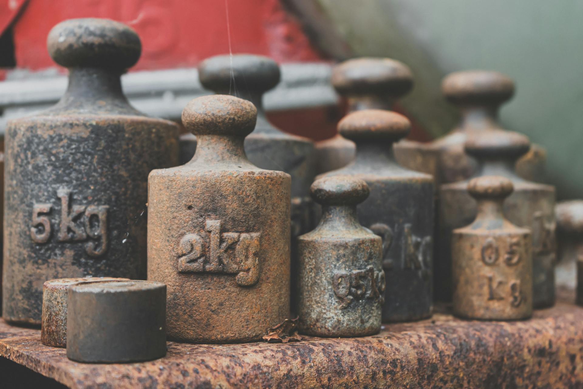 Rusty Set of Iron Weights For Scale In Close Up View