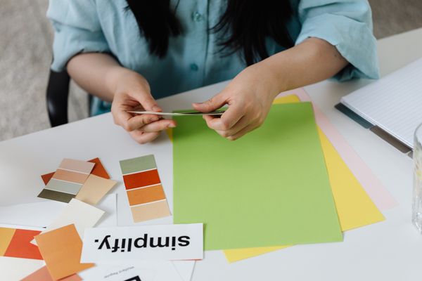 Designer arranging paper colour swatches — photo by Kaboompics.com on Pexels