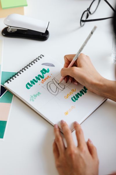Hand lettering in a sketchbook — kaboompics on Pexels