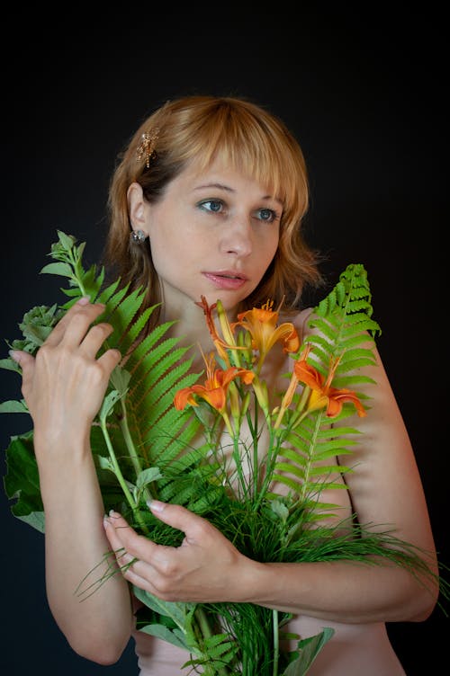 Free A Woman Holding a Bouquet of Flowers Stock Photo