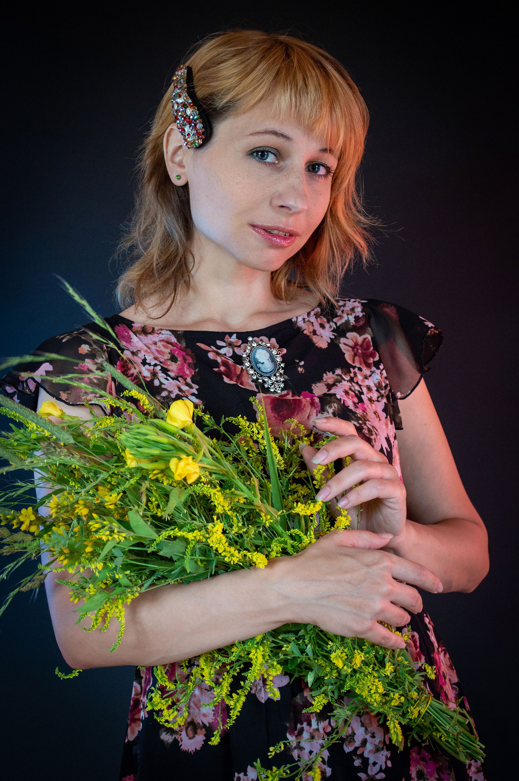 A Woman in a Floral Top Holding a Bouquet of Flowers · Free Stock Photo