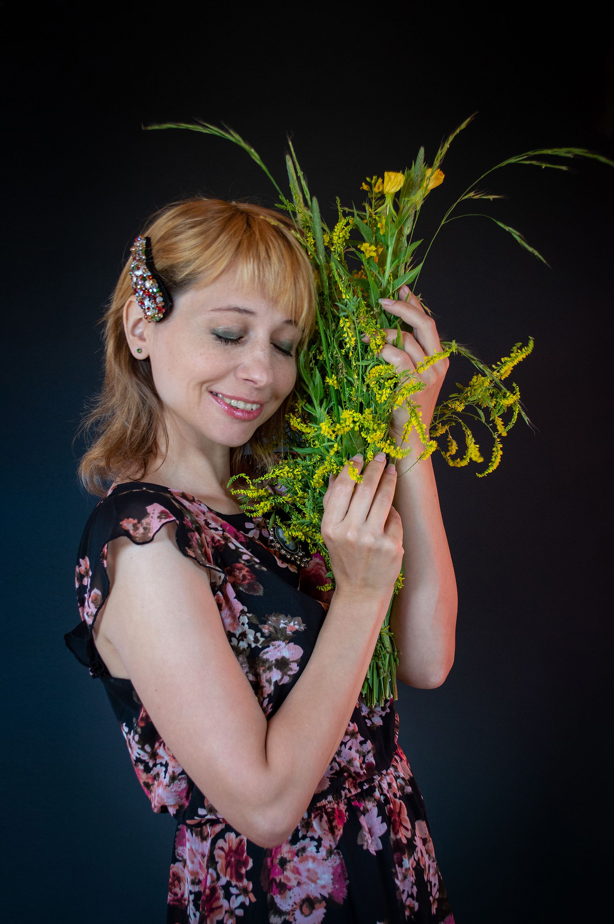 A Woman in a Floral Top Holding a Bouquet of Flowers · Free Stock Photo