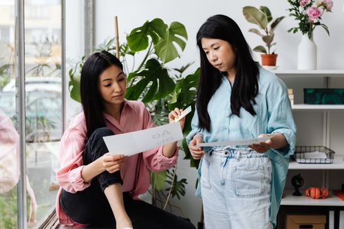 Free Two women collaborate in a stylish office space, reviewing design concepts. Stock Photo