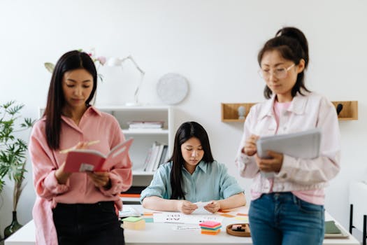 Three young women brainstorming in a modern office, sharing ideas and collaborating on a project.