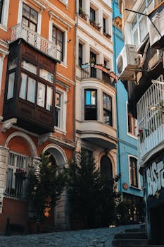 Vibrant street scene in Istanbul showcasing colorful, historic apartment buildings and unique architectural details.