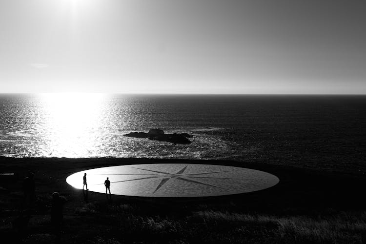 Compass On Shore In Black And White