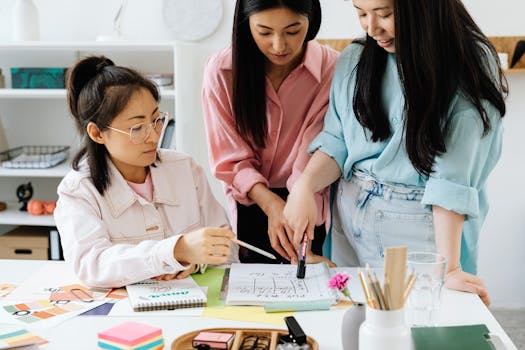 Three women brainstorming and planning in a bright, modern office setting.