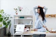 Woman in Blue Long Sleeve Shirt Sitting on Table