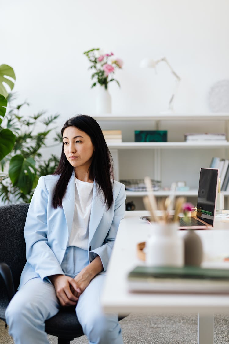 Woman In Light Blue Blazer And Pants Sitting On Chair 