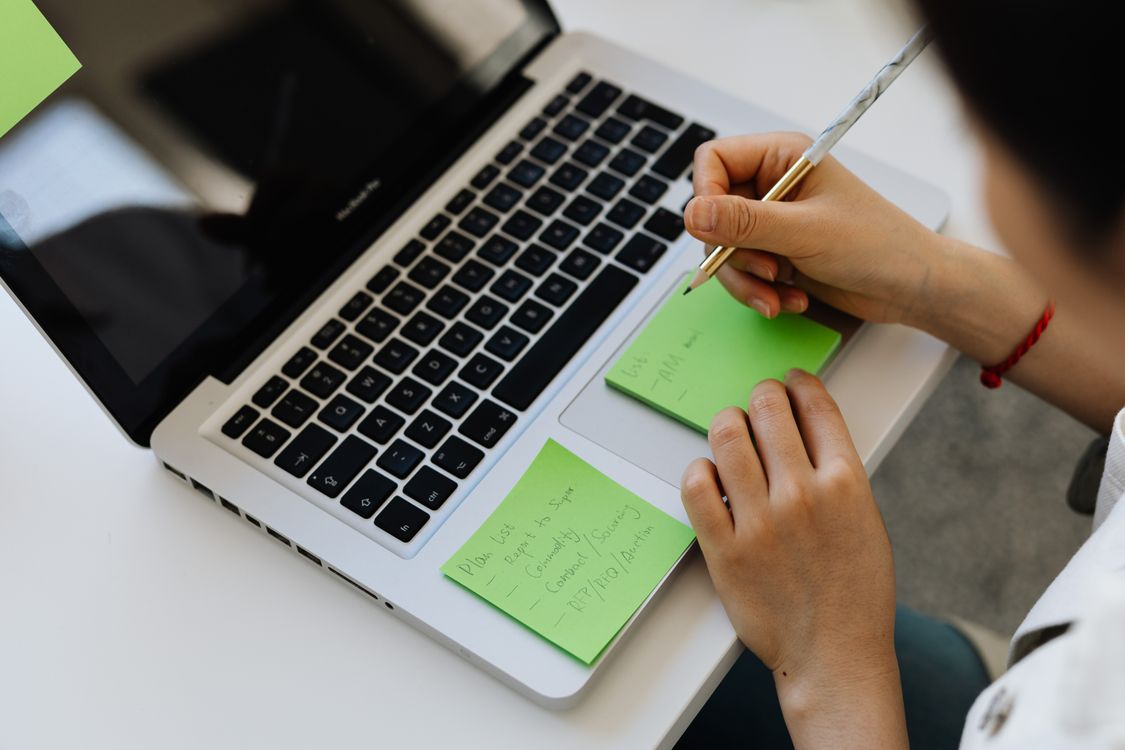 Person Writing on Green Sticky Notes · Free Stock Photo