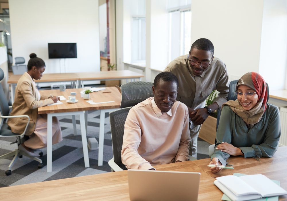 People reviewing content on a laptop screen
