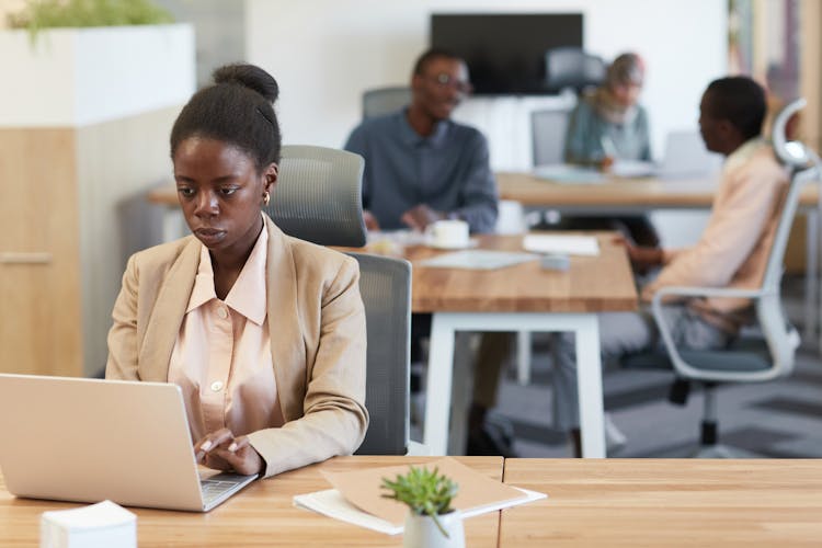 Woman Wearing Blazer Using A Laptop