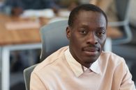 Man in White Polo Shirt Sitting on Gray Chair