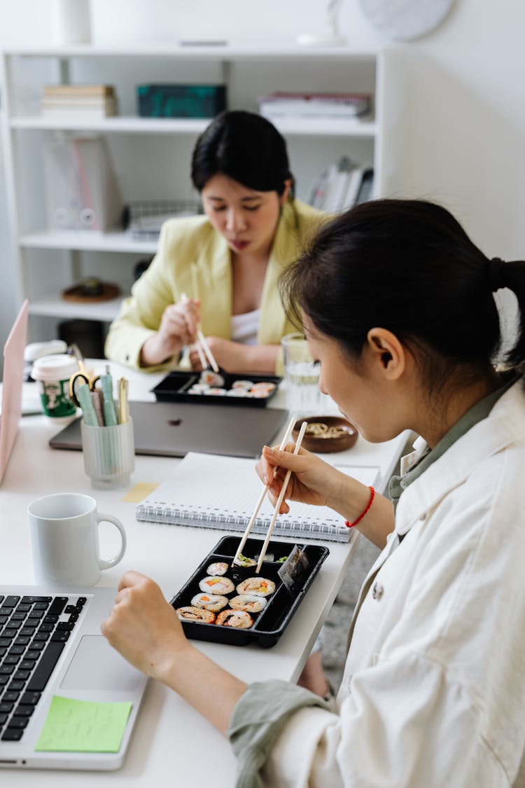 Women Eating Using Chopsticks