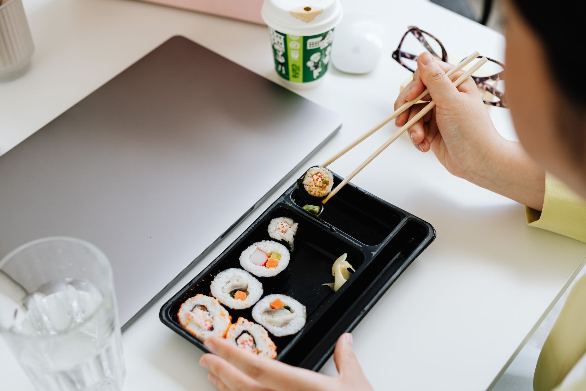 Person Holding Chopsticks and Tray With Food