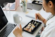 Person Holding Chopsticks on White Ceramic Plate
