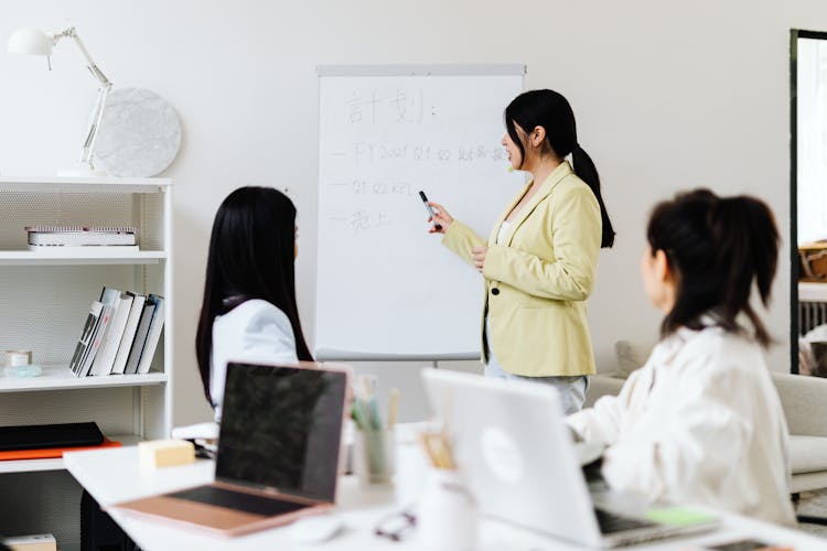 Woman Presenting To Her Coworkers