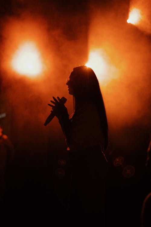 A Silhouette of a Woman Singing