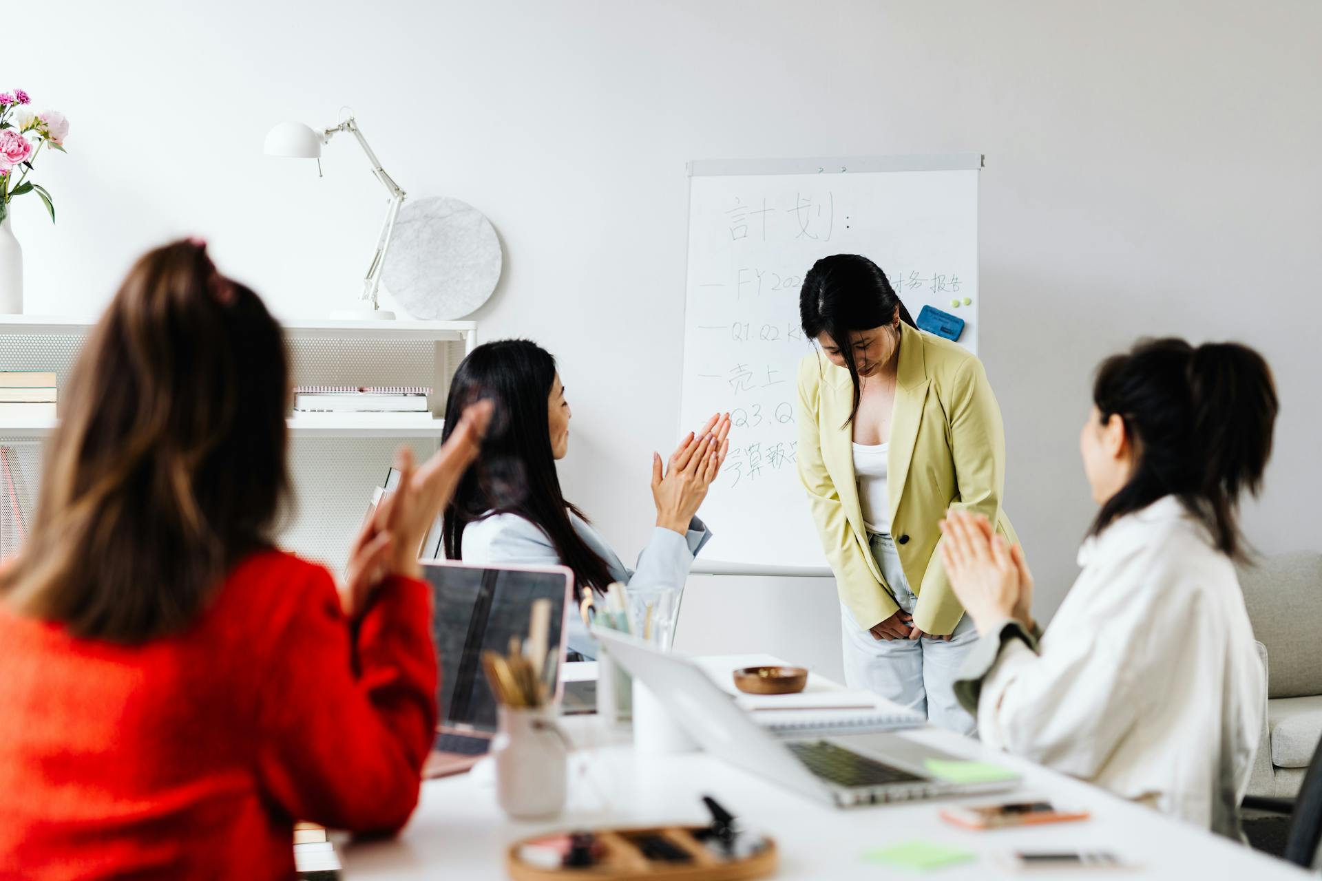 A Woman being Praised after a Presentation