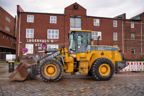 A Wheel Loader in front of a Brick Building