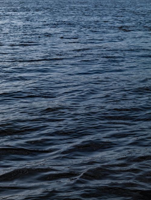 Free Calm ocean waves creating a soothing seascape at dusk, perfect for tranquility themes. Stock Photo