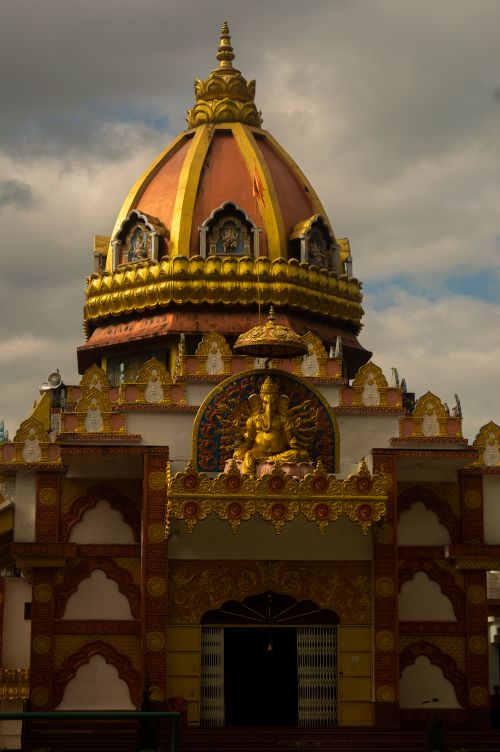 Free Beautiful temple with a traditional dome, showcasing intricate Indian architecture under cloudy skies. Stock Photo