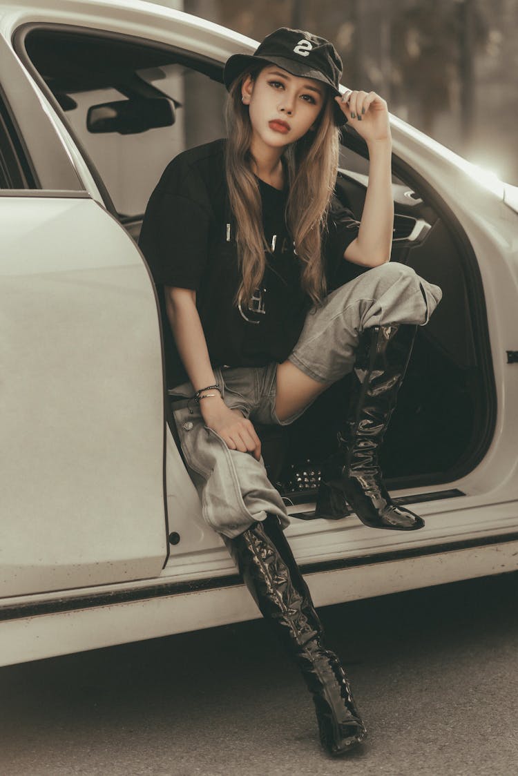 Woman Wearing A Black Shirt Sitting In The Car Posing