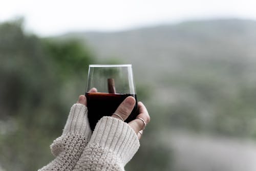 Person Holding a Glass of Wine