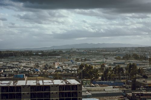 Free Aerial view of a sprawling urban landscape under a moody overcast sky. Stock Photo