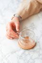 Crop female hand holding cup