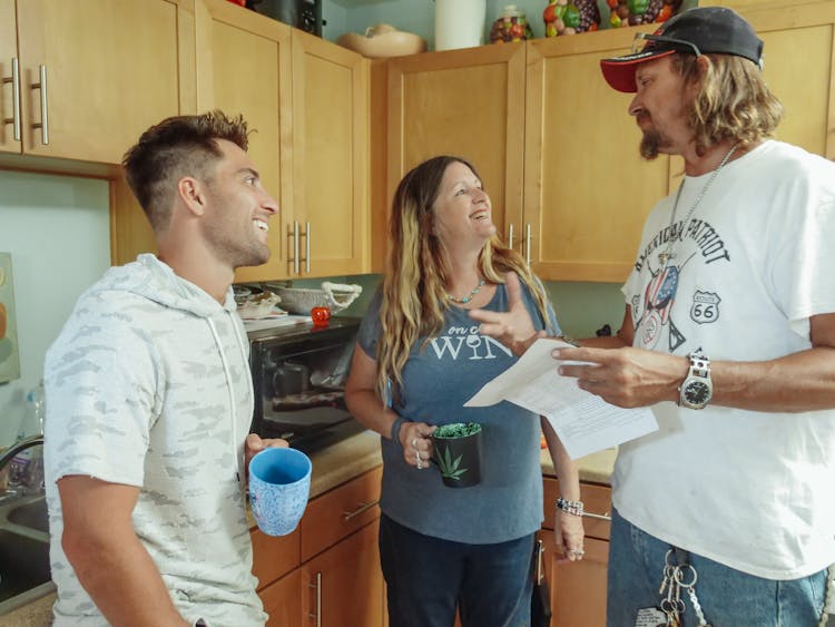 Happy Family Talking At The Kitchen